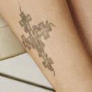 Drew Barrymore Cross Ankle Tattoo